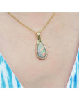4.30 ct. solid Australian opal teardrop pendant with halo diamonds on an 18K yellow gold chain.