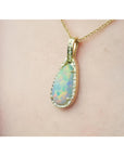 4.30 ct solid Australian opal pendant with fiery red-orange flashes, halo diamonds, 18K yellow gold chain.