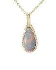 An Australian opal pendant necklace with gold chain showing the pear shaped gold and diamonds frame.