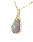4.30 ct solid Australian opal pendant with fiery red-orange flashes, halo diamonds, 18K yellow gold.
