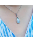 Pear-shaped Australian white opal pendant with red-orange play of color, set in 18k white gold on a silver chain.