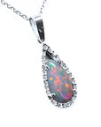 A solid natural Australian pear red opal surrounded by a halo diamond in white gold pendant, shows its right-side profile.