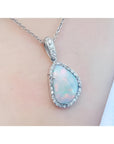 4.78 ct. solid Australian white opal pendant with red/orange flashes, halo diamonds, and 18K white gold chain.