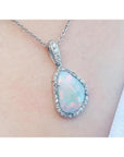 4.78 ct. solid Australian white opal pendant with red/orange flashes, halo diamonds, and 18K white gold chain.