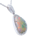 A white solid Australian opal surrounded by a frame with diamonds on a gold chain displaying its righ-side profile.