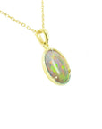 Gold necklace with an oval opal pendant on a right profile position.