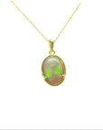 Opal pendant necklace on a gold chain against a white background