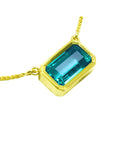Natural emerald solitaire necklace bezel set east-west orientation handcrafted in 18k yellow gold