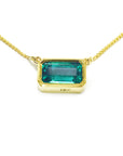 Emerald-cut emerald solitaire women's necklace east-west orientation handcrafted in 18k yellow gold