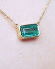 Muzo Colombia Emerald solitaire necklace for sale east-west orientation handcrafted in 18k yellow gold