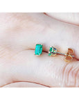 Emerald cut emerald stud earrings, 0.78 ct, in 14K yellow gold basket settings with push backs.