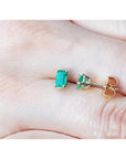 Emerald cut emerald stud earrings, 0.78 ct, in 14K yellow gold basket settings with push backs.