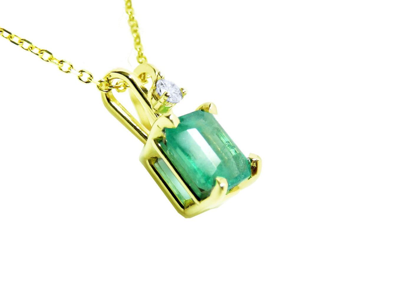 Gold pendant with a genuine colombian emerald on its right-side position, top and gallery visibles.