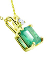 Gold pendant with a genuine colombian emerald on its right-side position, top and gallery visibles.