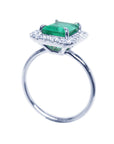 A 14k white gold emerald ring for women on its lateral underside profile top, gallery and band view.