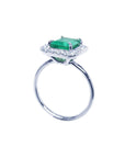A 14k white gold emerald ring for women on its lateral underside profile top, gallery and band view.