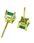 A pair of yellow gold emerald stud earrings in 14k yellow gold upside down downside visibles.
