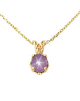 This natural star pink sapphire pendant necklace shows its asterisk under a LED bulb light and it is made of 14kgold.