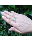2.00 ct. natural baguette emerald stud earrings in 14k white gold, worn on a hand.