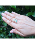 2.00 ct. natural baguette emerald stud earrings in 14k white gold, worn on a hand.