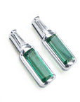 Two baguette cut emerald stud earrings with tapered baguette diamonds on top, white gold.