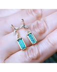 14K gold stud emerald leaf earrings with vibrant rectangular Colombian emeralds and diamonds.