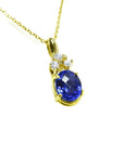 14K yellow gold pendant with oval tanzanite and three round diamonds on a delicate chain.