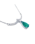 Emerald necklace natural Colombian emerald dangling from a wavy central bar with diamonds pave set in 14k white gold