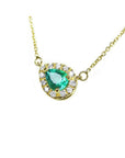 Emerald pear shaped necklace with diamond halo on 14K yellow gold chain.