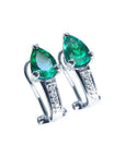 Pair of pear-shaped emerald clip-on earrings with diamond accents in 14K white gold.
