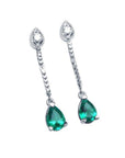 Pear-shaped Muzo Colombian emerald dangle earrings in 14K white gold with diamond posts.