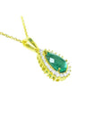 14K gold teardrop emerald pendant with a natural diamond halo on a delicate chain.