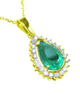 Gold pendant with a teardrop-shaped natural emerald surrounded by a halo of genuine diamonds