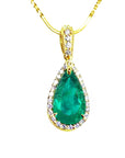 Teardrop-shaped emerald pendant on a gold chain topside profile view against a white background