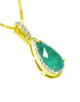 18K yellow gold pendant with a natural emerald teardrop-shaped gemstone on a right-side position top and gallery view.