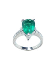 3.09 ct. pear-shaped deep green emerald ring with princess cut diamonds in 14K white gold.