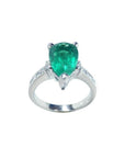 3.09 ct. pear-shaped deep green emerald ring with princess cut diamonds in 14K white gold.