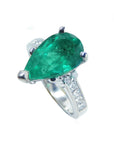 Side profile of a teardrop emerald and accent diamonds ring.