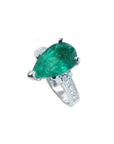 Pear-shaped deep green emerald ring with princess cut diamonds in 14K white gold.