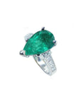 Pear-shaped deep green emerald ring with princess cut diamonds in 14K white gold.