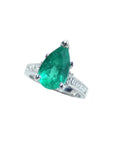 Ring with a natural Colombian teardrop emerald and diamond accents on a white background.