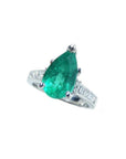 3.09 ct. pear-shaped deep bluish-green emerald ring with princess cut diamonds in 14K white gold.