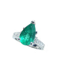 3.09 ct. pear-shaped deep bluish-green emerald ring with princess cut diamonds in 14K white gold.