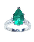 A topside view of a teardrop emerald ring white gold with accent diamonds.