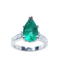 A topside view of a teardrop emerald ring white gold with accent diamonds.