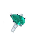 3.09 ct pear-shaped deep bluish-green emerald ring with princess-cut diamonds in 14K white gold.