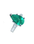 3.09 ct pear-shaped deep bluish-green emerald ring with princess-cut diamonds in 14K white gold.