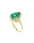 A yellow gold emerald ring with the top and band on side profile position.