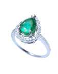 Pear shaped natural emerald ring in white gold, top and side perspective view.