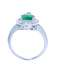 The lateral view of a natural emerald ring in white gold, top setting, gallery and band design visibles.
